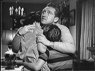 Joe Smith holds his family during a rain storm